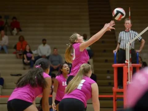 a group of people playing volleyball