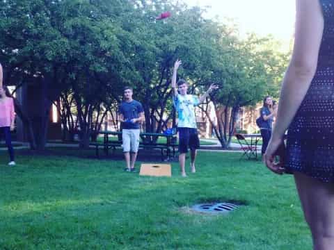 a group of people playing frisbee in a park