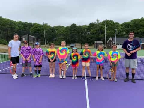 a group of people holding tennis rackets