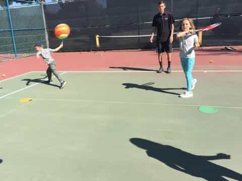 a girl hitting a ball with her bat