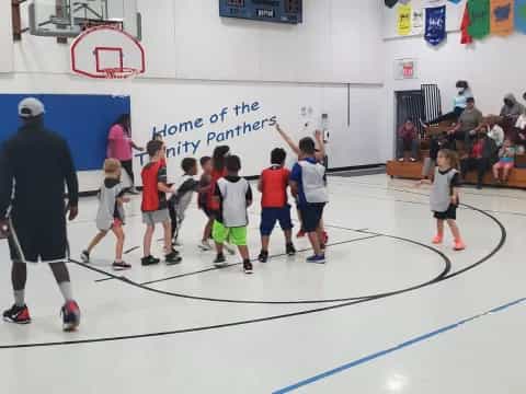 a group of kids playing basketball