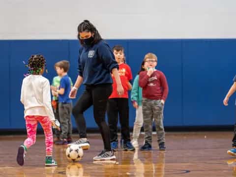 a person and kids playing football