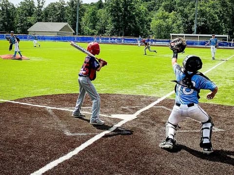 a baseball player prepares to swing a bat