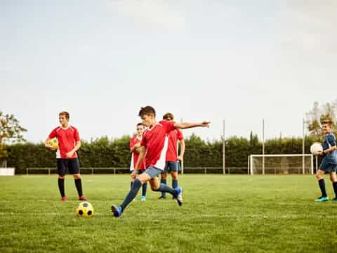 a group of kids playing football