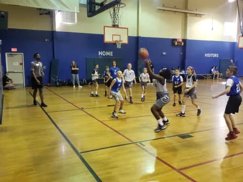a group of people playing basketball
