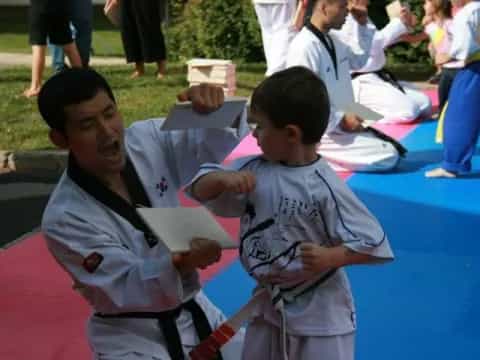 a group of children in karate uniforms
