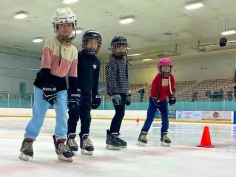 a group of people wearing helmets and roller skates