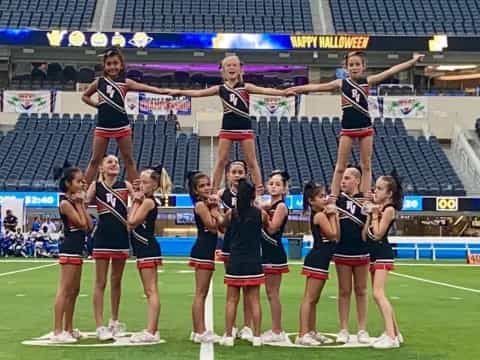 a group of cheerleaders on a field
