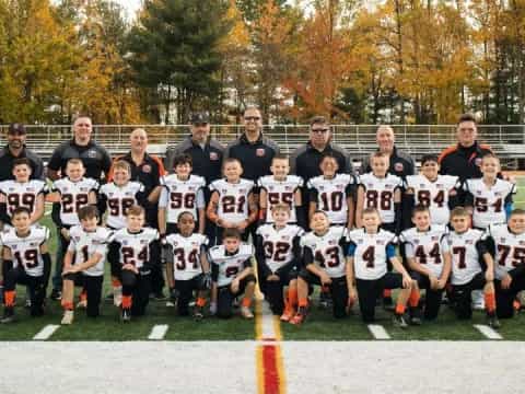 a group of people posing for a photo on a field