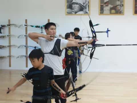 a group of people holding bows and arrows