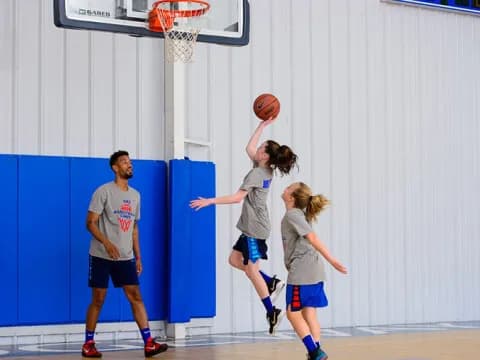 a group of people playing basketball