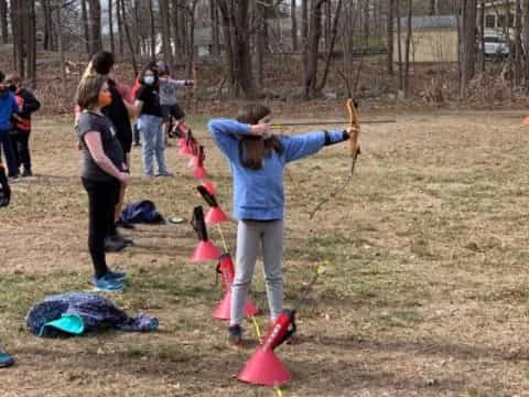 a group of people playing with sticks