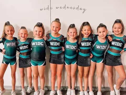 a group of girls in matching outfits