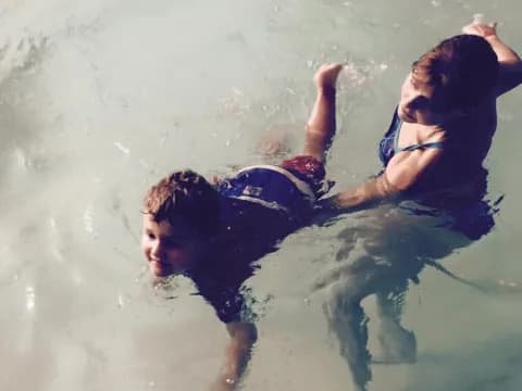 a woman and a man swimming in water