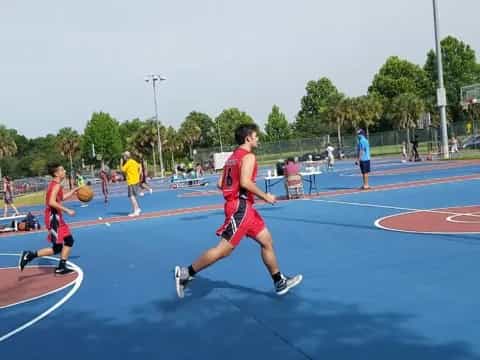 a group of people playing basketball