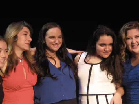 a group of women posing for a photo