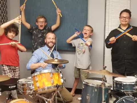 a group of people playing drums