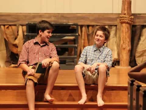a couple of men sitting on a bench