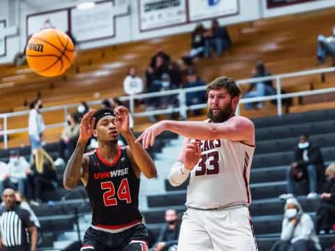 a couple of men playing basketball