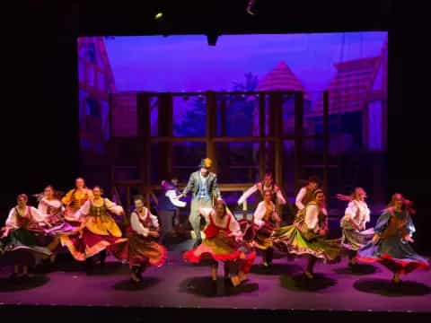 a group of people dancing on a stage
