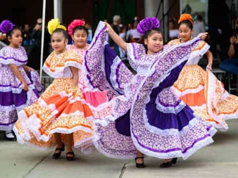 a group of women in colorful dresses