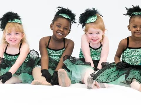 a group of young girls sitting on the floor