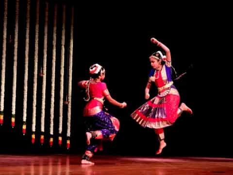 a couple of women dancing on a stage