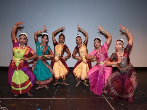 a group of women in colorful dresses