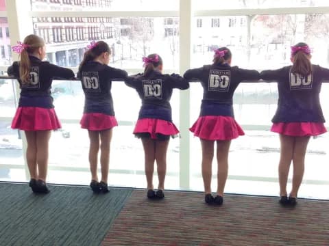 a group of girls wearing matching outfits