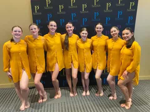 a group of girls in yellow uniforms