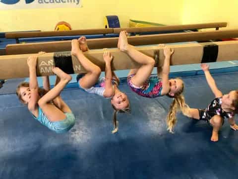 a group of women doing a yoga pose on a mat