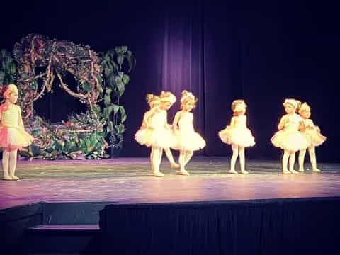a group of children performing on a stage