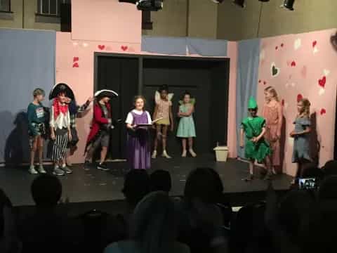 a group of children performing on a stage