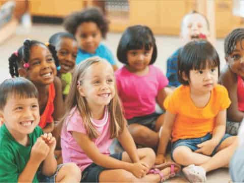 a group of children sitting on the floor