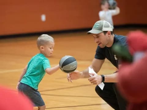 a person and a boy playing volleyball