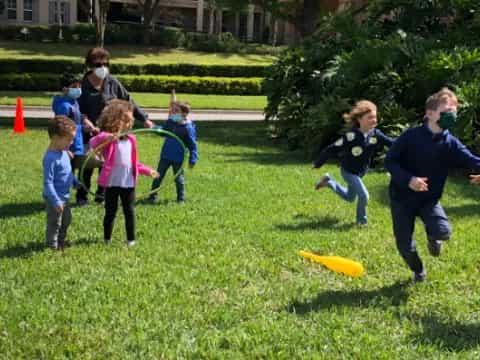 a group of kids playing with a frisbee