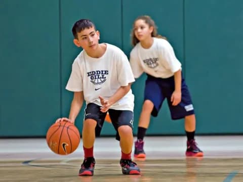 a couple of kids playing basketball