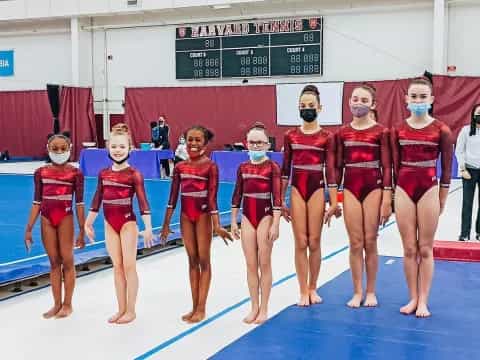 a group of women in leotards posing for a photo