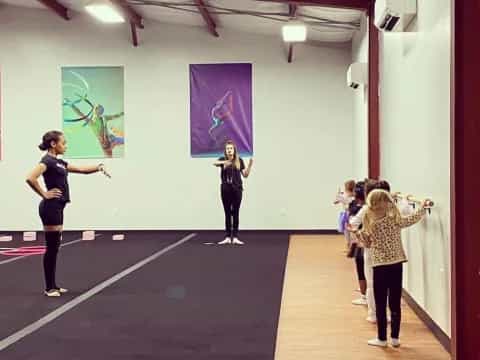 a group of women exercising in a gym
