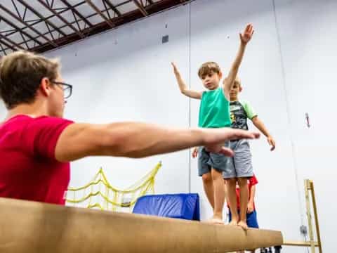 a man holding a child on a trampoline