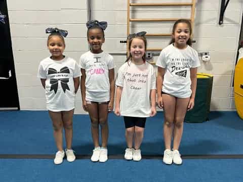 a group of girls wearing white shirts