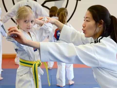 a group of girls in karate uniforms