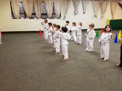 a group of children in white karate uniforms