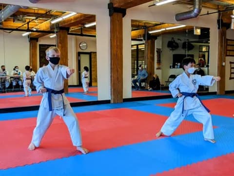 two people in white karate uniforms