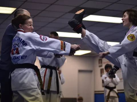 a couple of women in karate uniforms