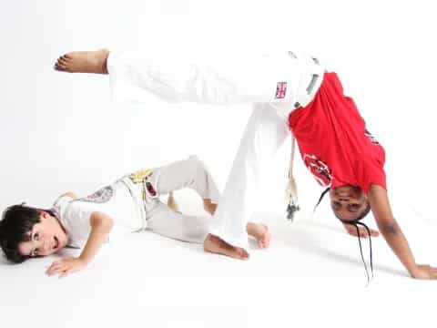 a couple of boys in karate uniforms