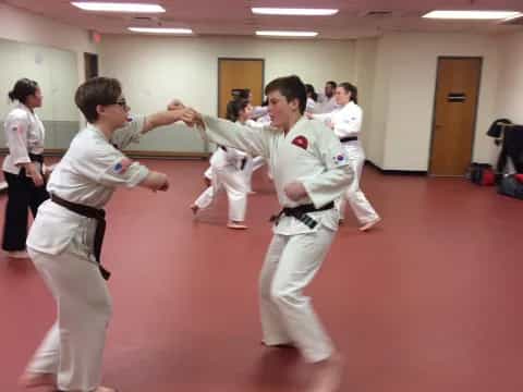 a group of people in karate uniforms