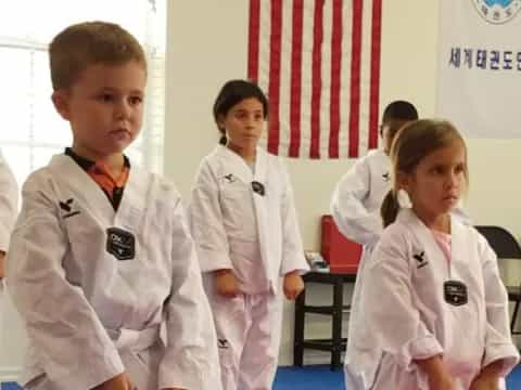 a group of children in karate uniforms