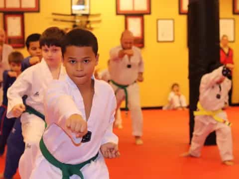 a group of children in karate uniforms