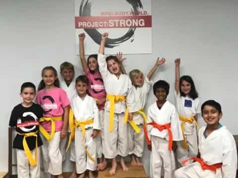 a group of people in karate uniforms